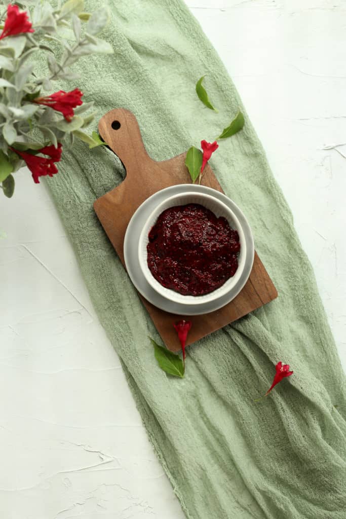 triple berry chia seed jam in a white bowl on a green linen napkin