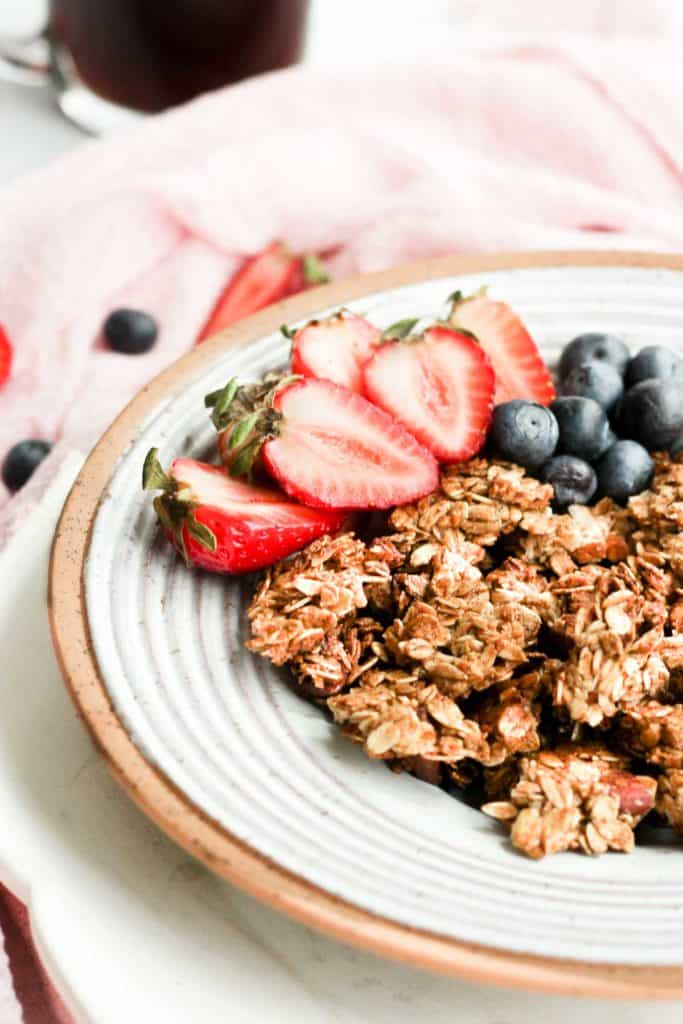 healthy vegan, gluten free granola in bowl with berries.