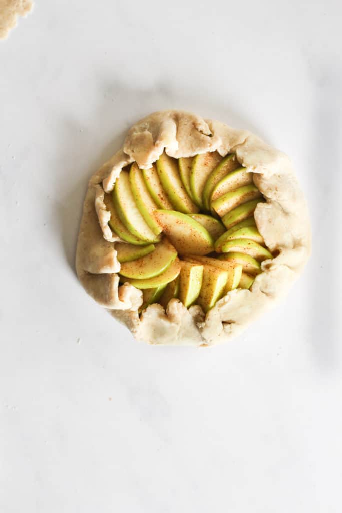 uncooked apple galette on marble