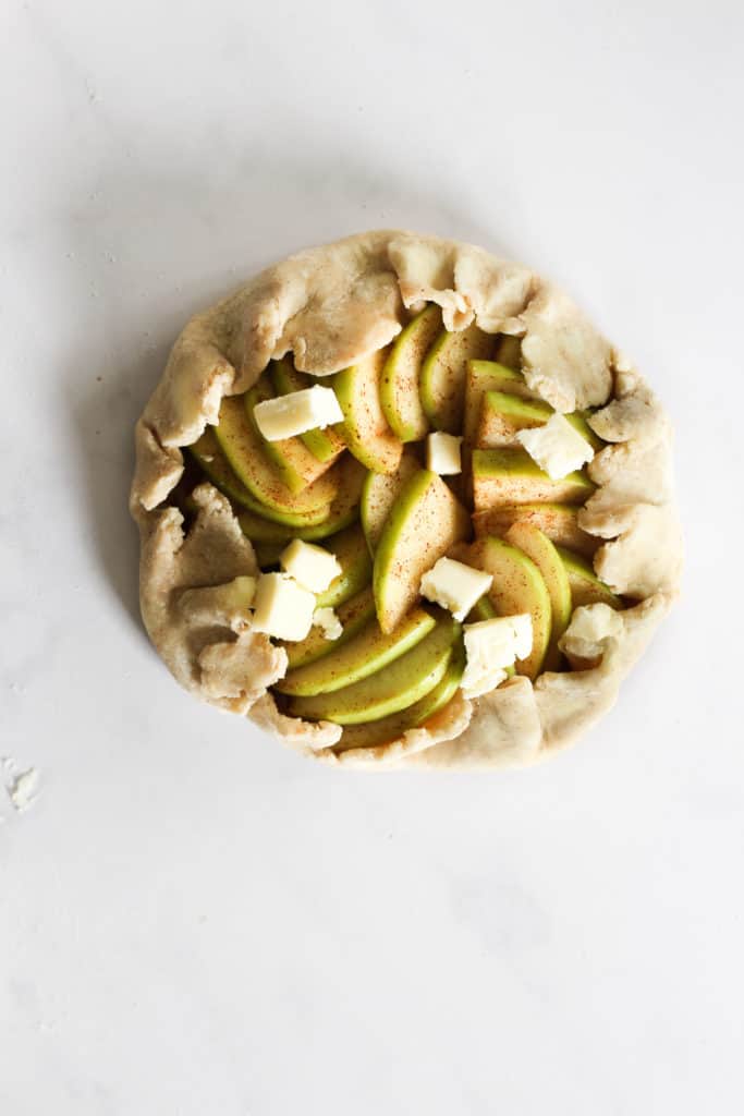 uncooked apple galette on marble