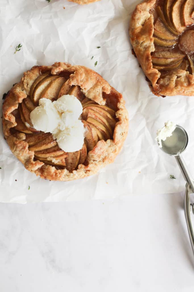 apple galette with vanilla ice cream on parchment paper