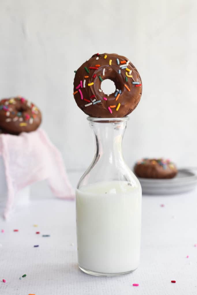 baked double chocolate cake donut on top of a milk jug
