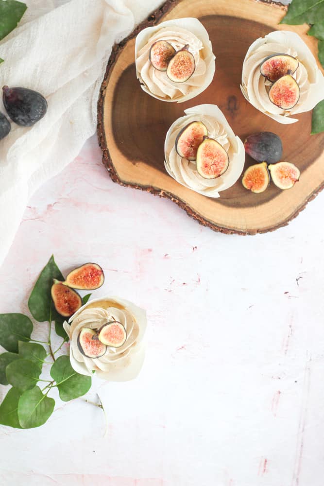 sugar free vanilla cupcakes topped with figs on a pink backdrop
