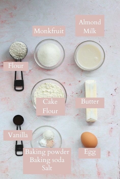 sugar free vanilla cupcake ingredients on a pink backdrop