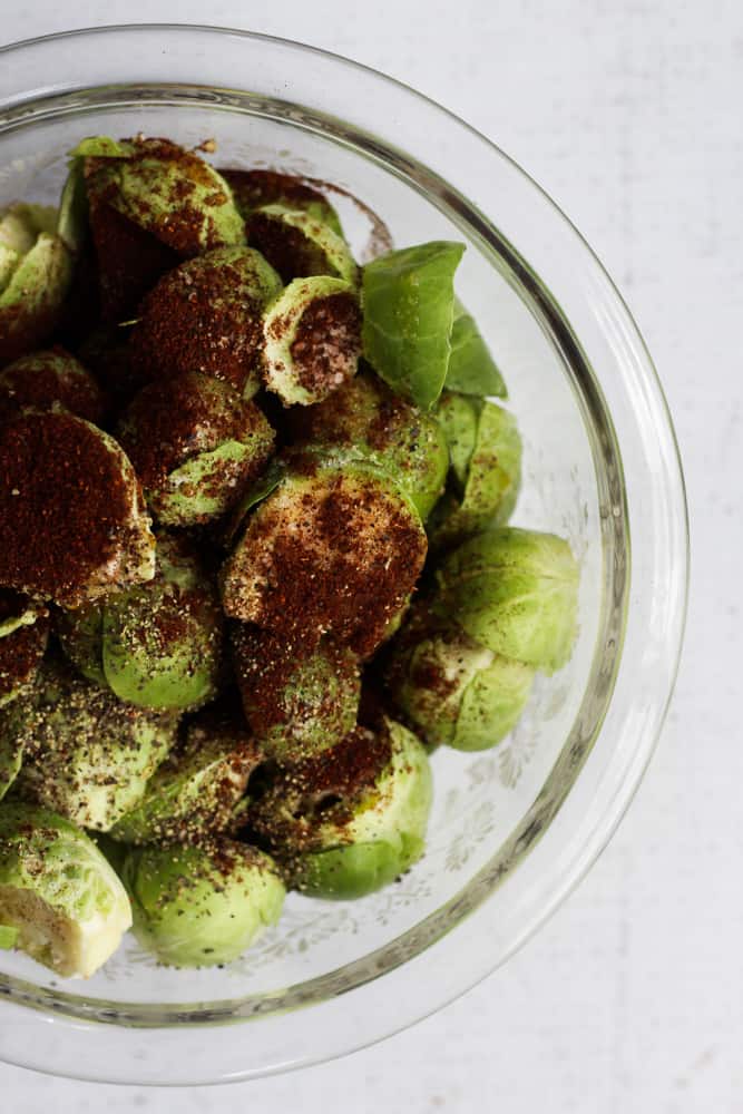 seasoned brussels sprouts in a clear bowl