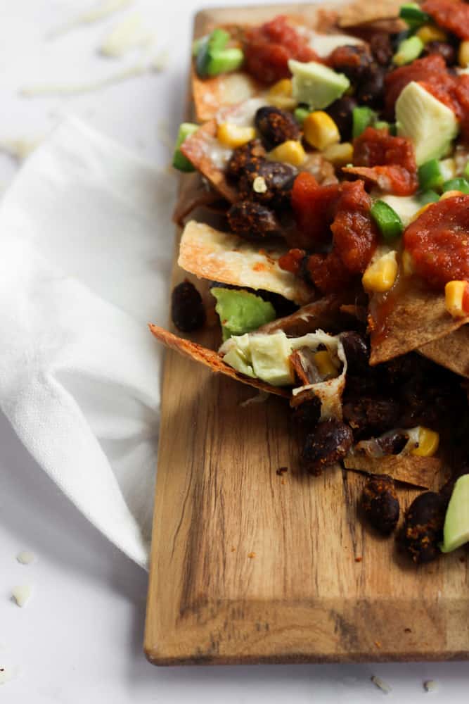 close up of healthy nachos on a wooden board