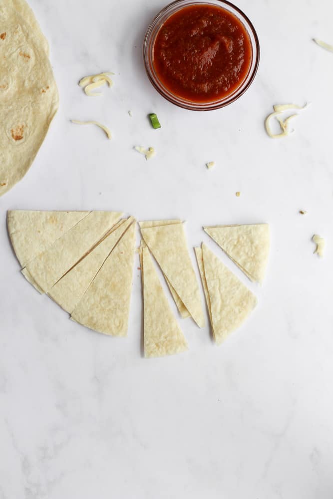 tortilla cut into triangles on white background