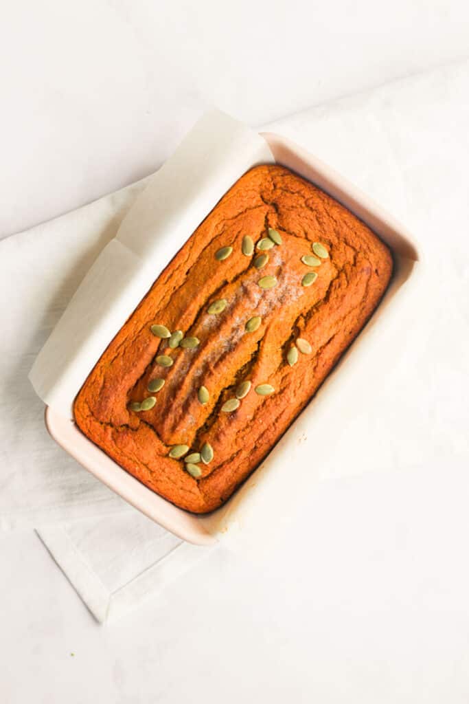 gluten and sugar free pumpkin bread baked in pink loaf pan.