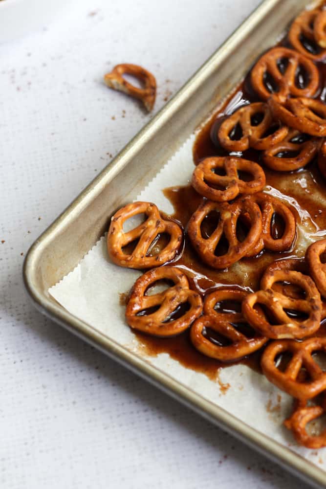 pumpkin spice pretzels coated in syrup on a baking sheet lined with parchment paper