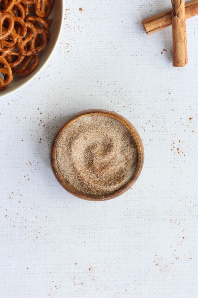 pumpkin pie spice mixed with sugar in a brown bowl on a white background