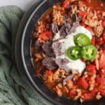 black bowl of 5 ingredient chili with a green napkin