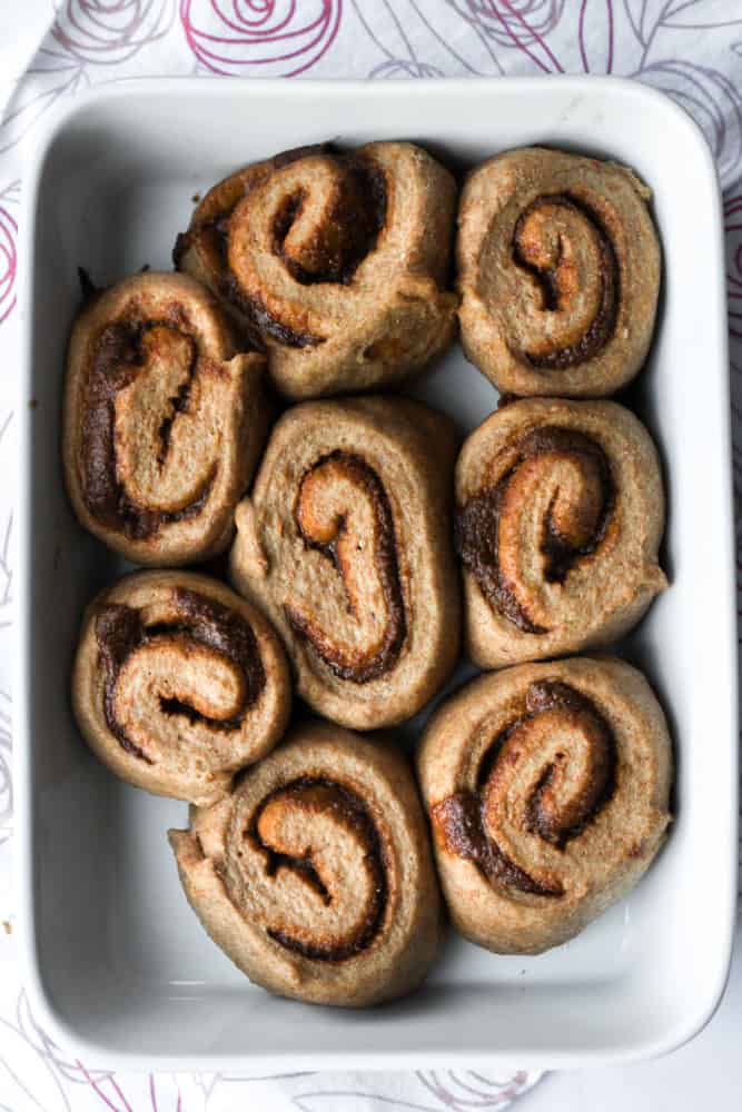 unbaked healthy cinnamon rolls in a white baking dish
