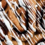 close up of healthy cinnamon rolls drizzled with a vanilla glaze