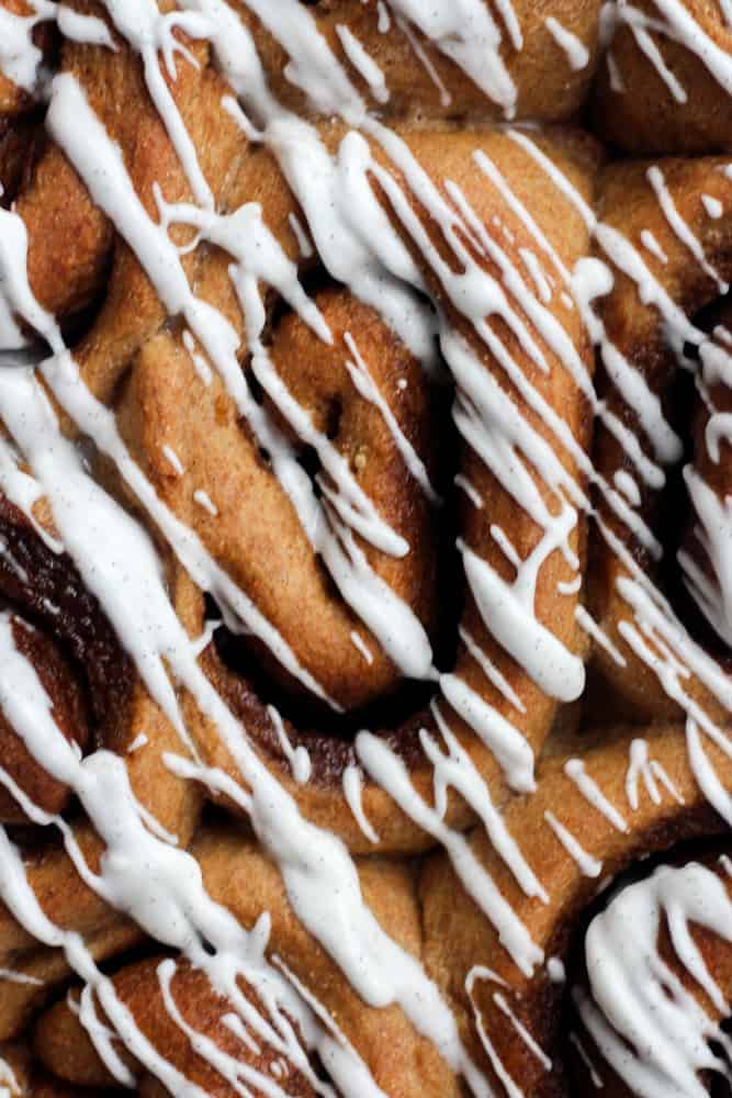 close up of healthy cinnamon rolls drizzled with vanilla glaze