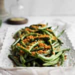 platter of spicy air fryer green beans with a light pink napkin
