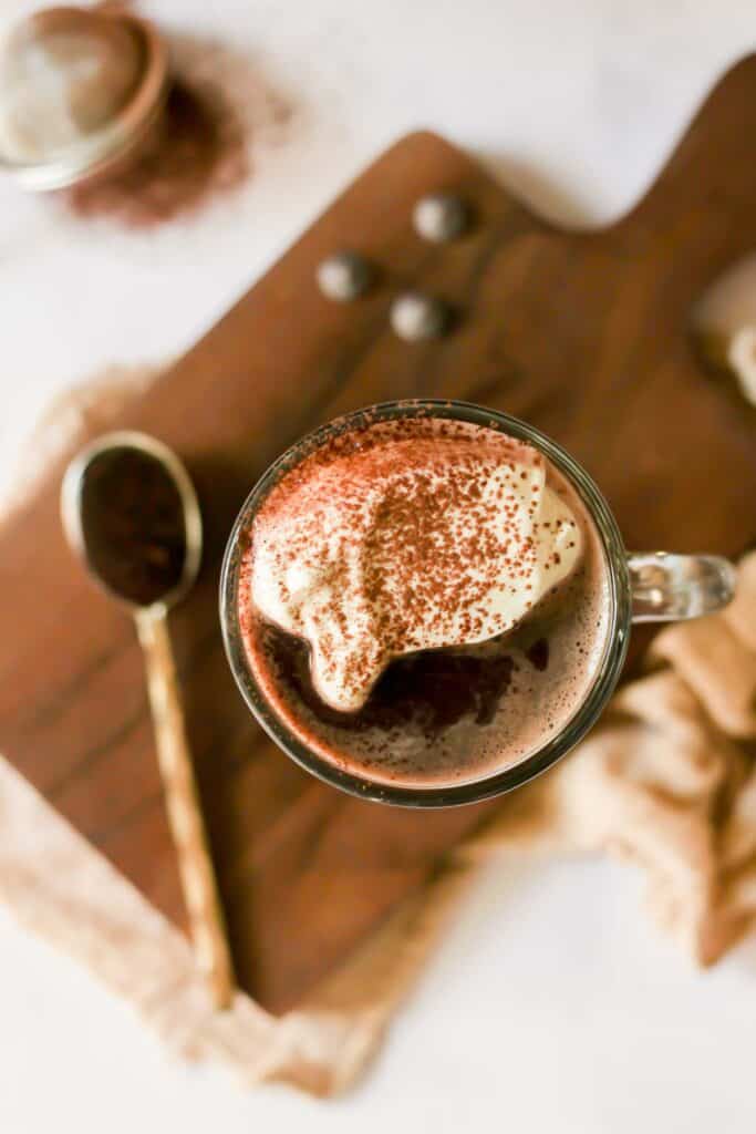 healthy sugar free hot chocolate topped with whipped cream and cocoa powder.