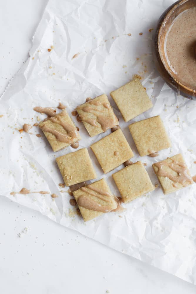 glazed simple shortbread cookies on a piece of crumpled parchment paper