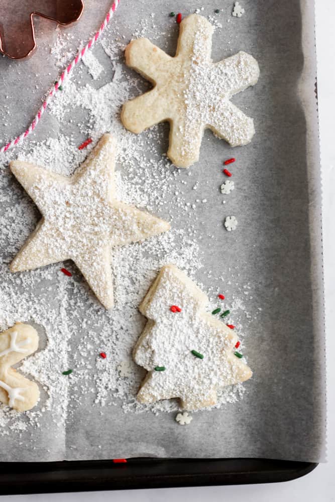 decorated healthy Christmas cookies on a parchment lined baking sheet