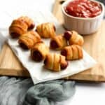 air fryer pigs in a blanket on parchment paper.