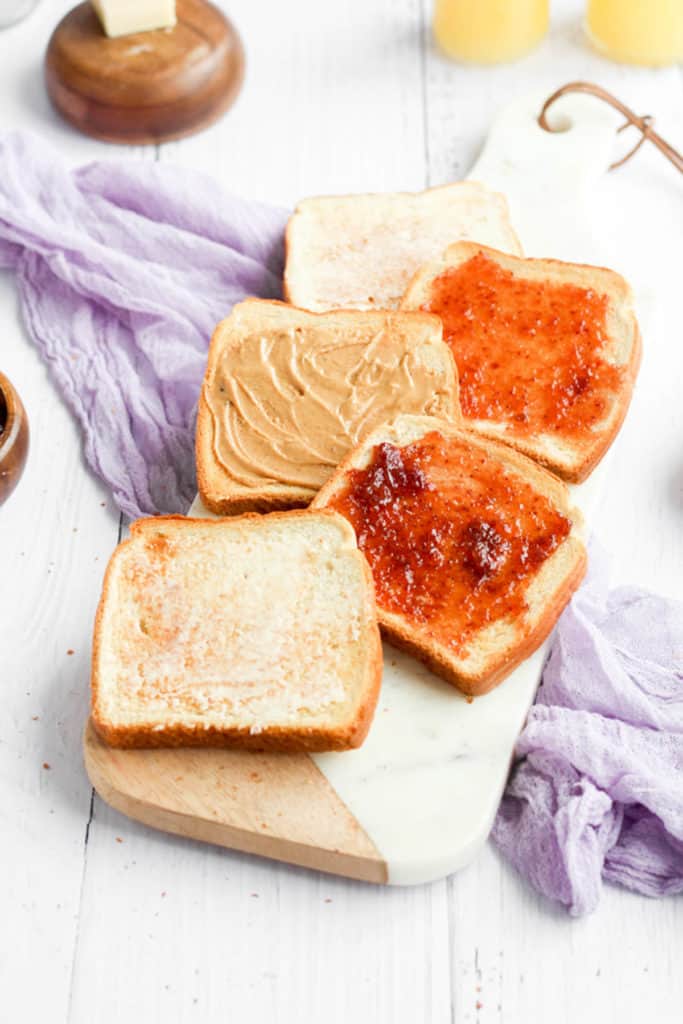 toast in the air fryer topped with butter and jelly.