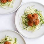 air fryer turkey meatballs over zucchini noodles on a white plate