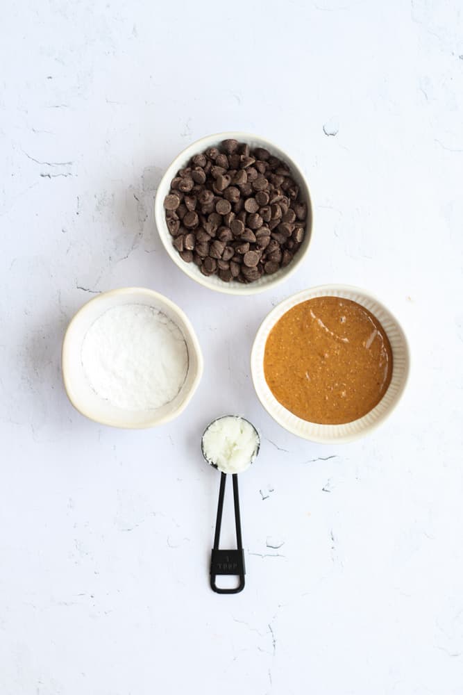 ingredients for almond butter cups on a white backdrop