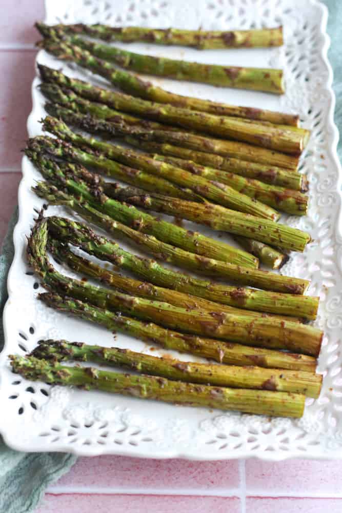 air fryer asparagus laid out on a white platter