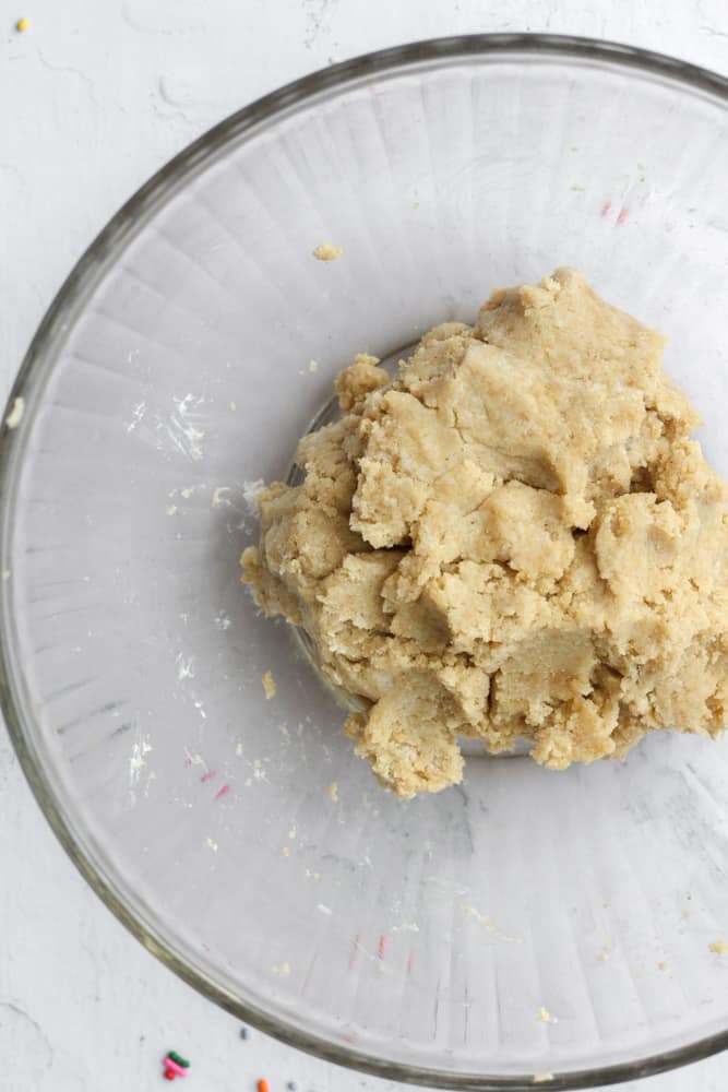 healthy cake pop dough in a clear bowl on a white backdrop