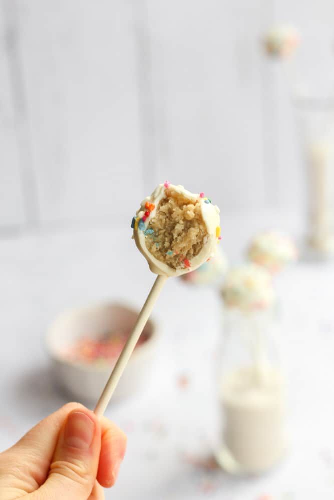 bite shot of a healthy cake pop with a hand holding it