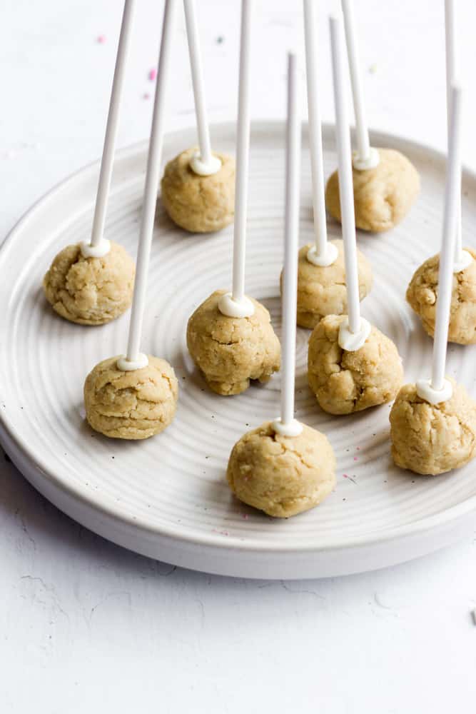 easy cake pops with sticks on a white plate