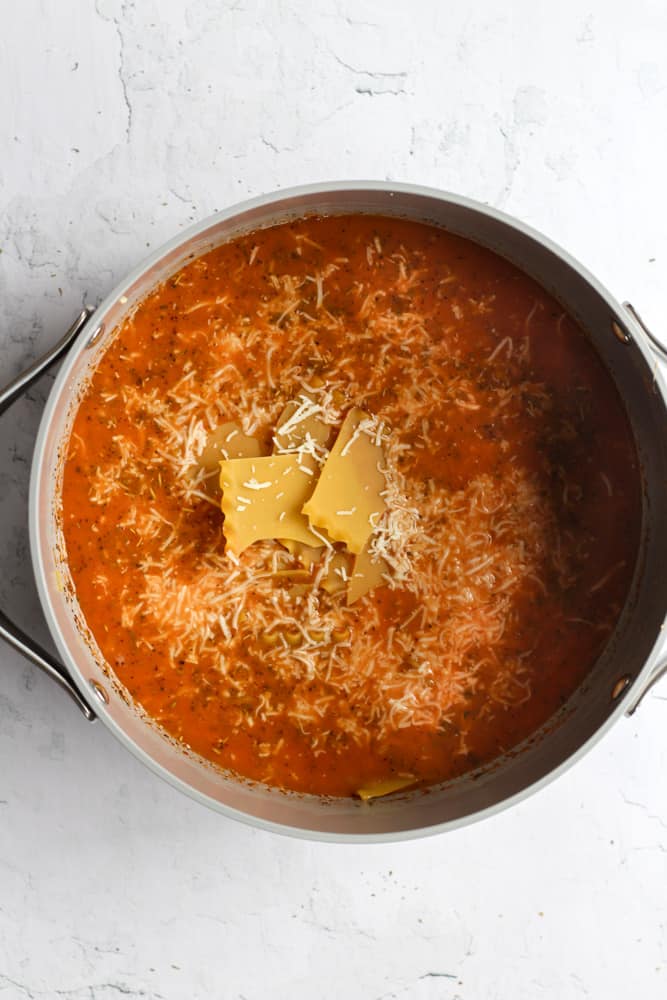gluten free lasagna soup in a gray pot on a white backdrop