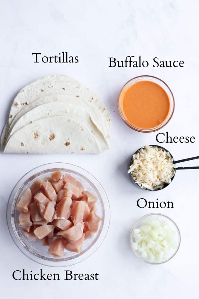 healthy buffalo chicken quesadilla ingredients on a white backdrop labeled with black text
