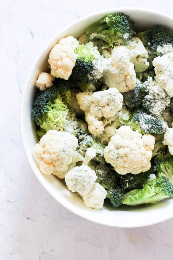 broccoli and cauliflower in a white bowl seasoned with ranch seasoning