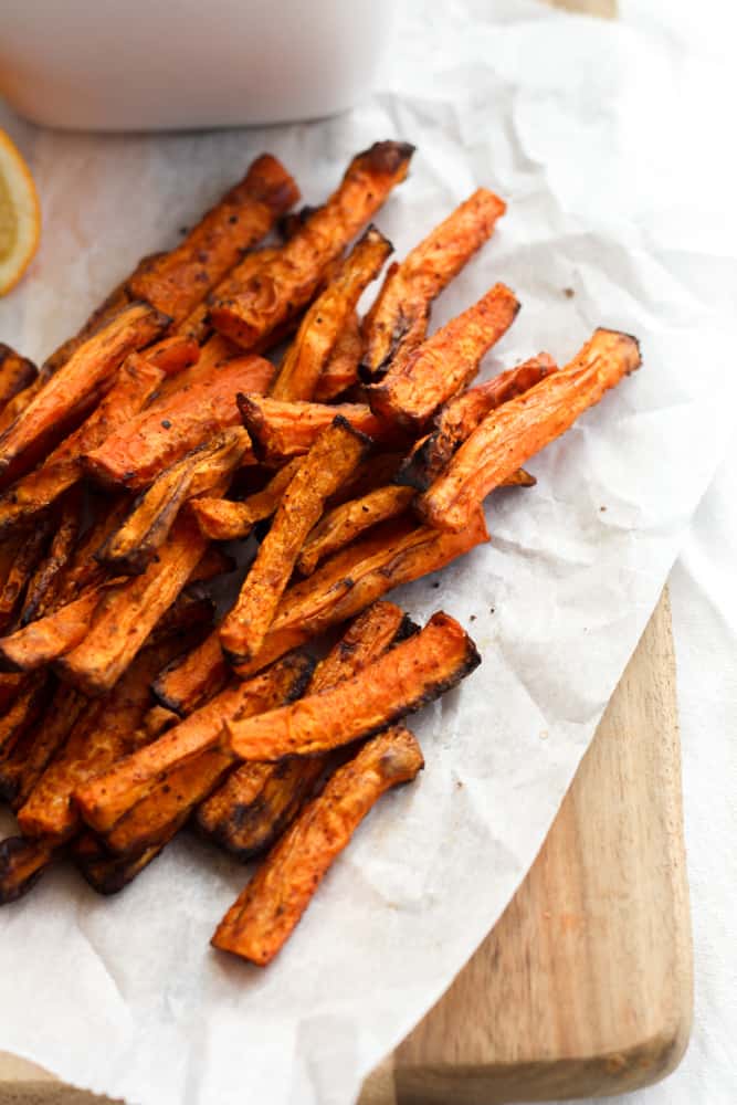 carrot fries cooked in the air fryer on parchment paper