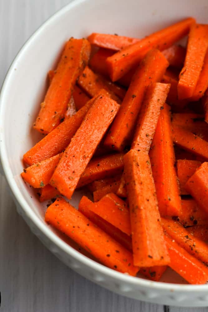 seasoned carrots in a white bowl
