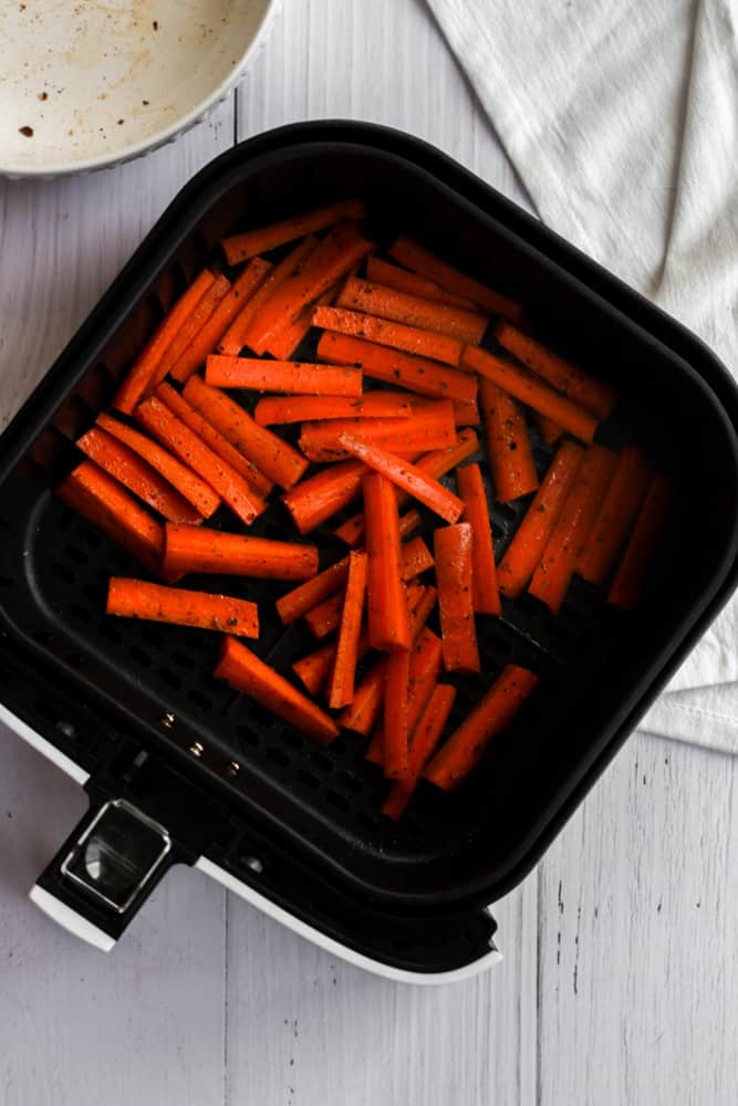 carrot sticks in an air fryer basket
