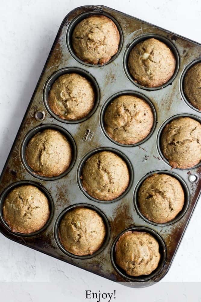 easy banana bread muffins baked in a dark gray tin on a white backdrop