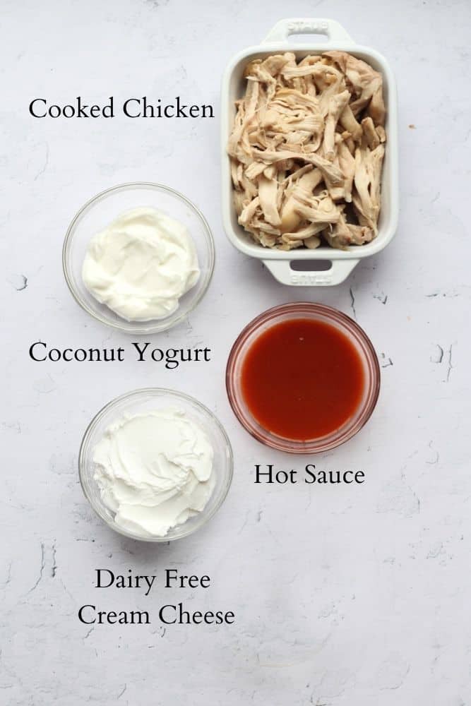 dairy free buffalo chicken dip ingredients on a white backdrop labeled with black text