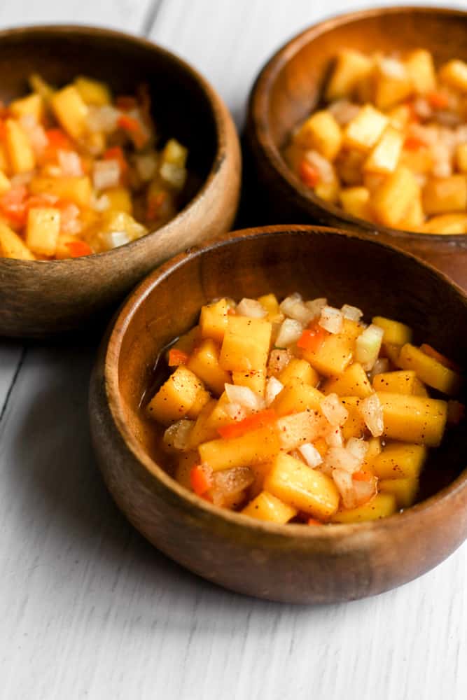 mango habanero salsa in 3 small wooden bowls.