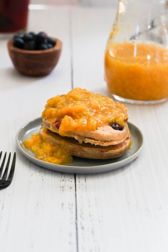 peach compote on blueberry pancakes.