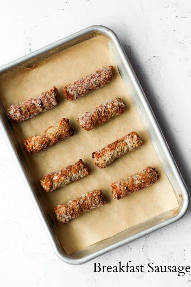 frozen breakfast sausage on a parchment lined baking sheet.