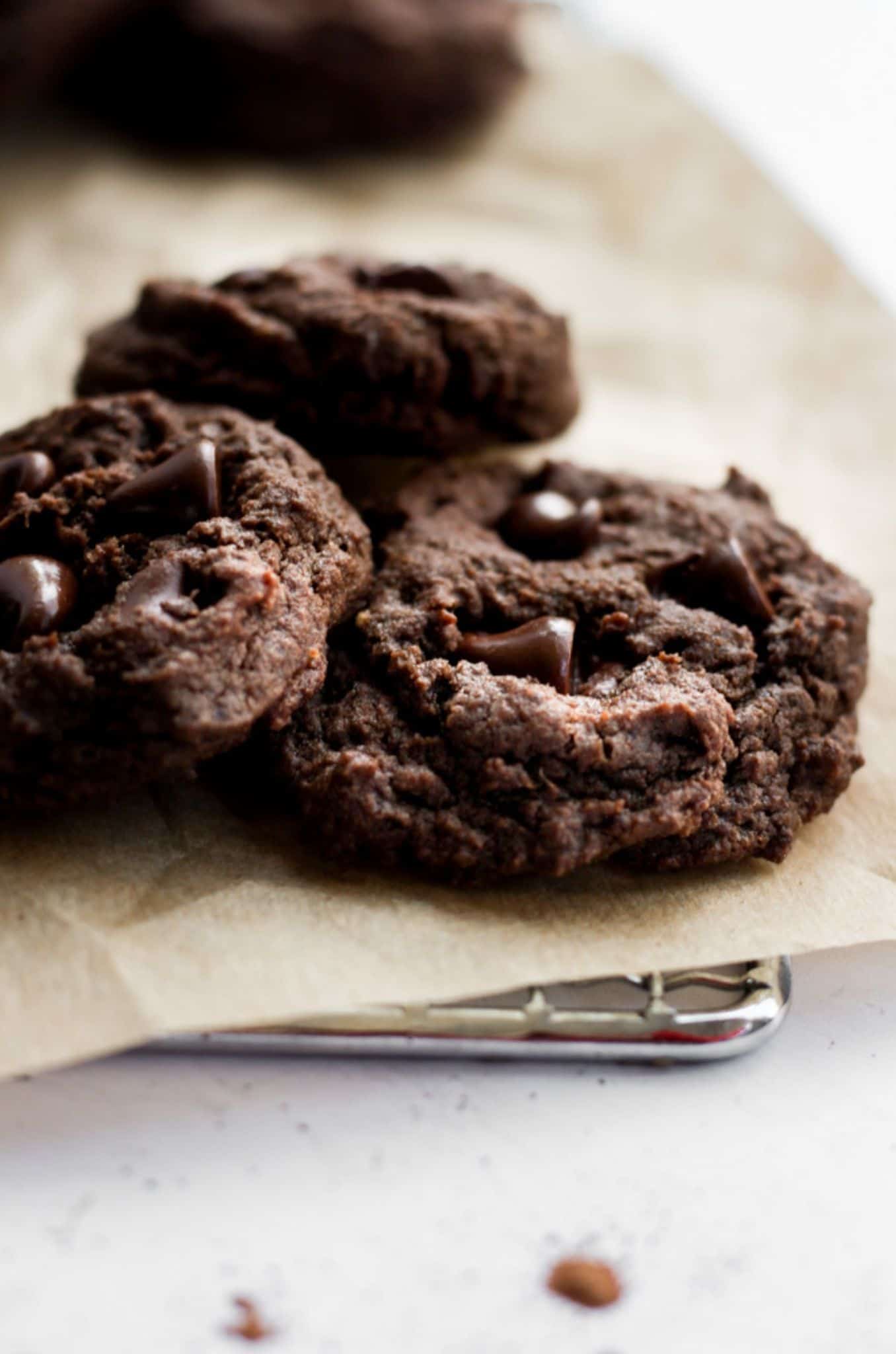 eggless chocolate cookies on brown parchment paper.
