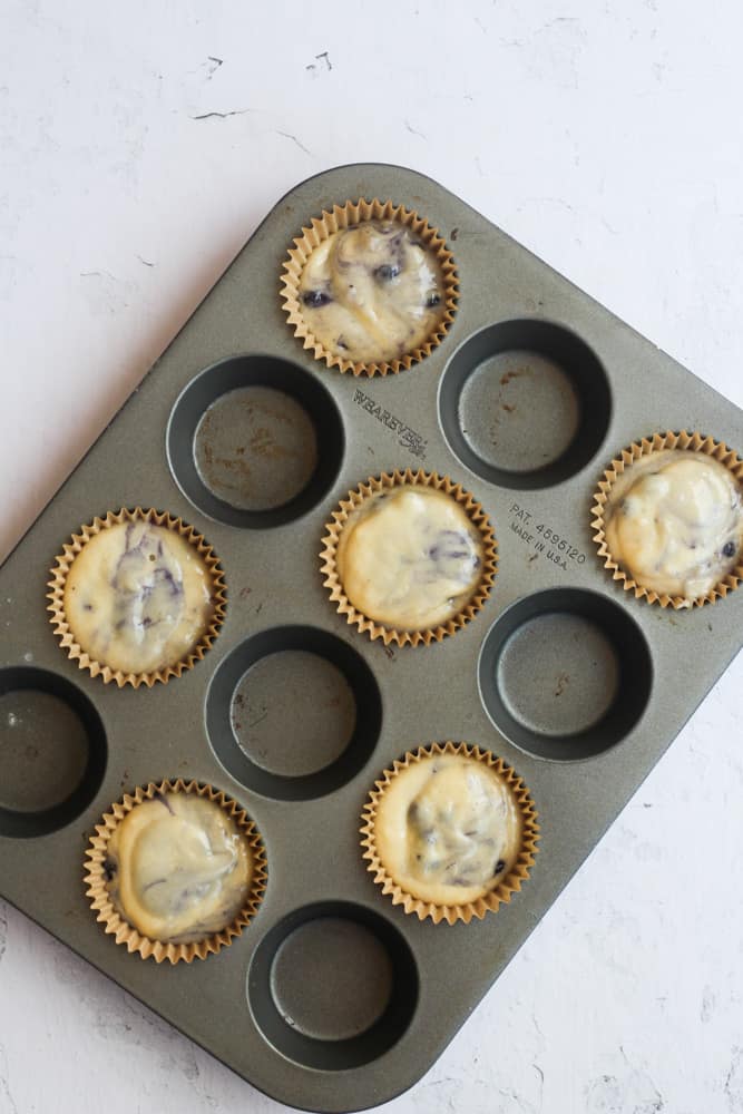 healthy blueberry muffins in a muffin tin.