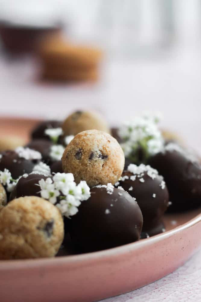 healthy cookie dough bites on a tan plate.
