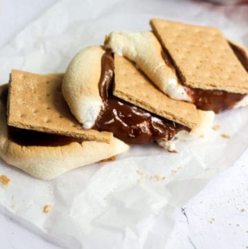 three air fryer s'mores on parchment paper.