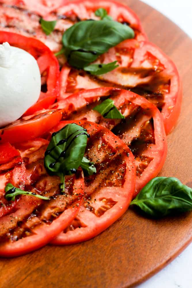 sliced tomatoes with balsamic glaze and burrata cheese.