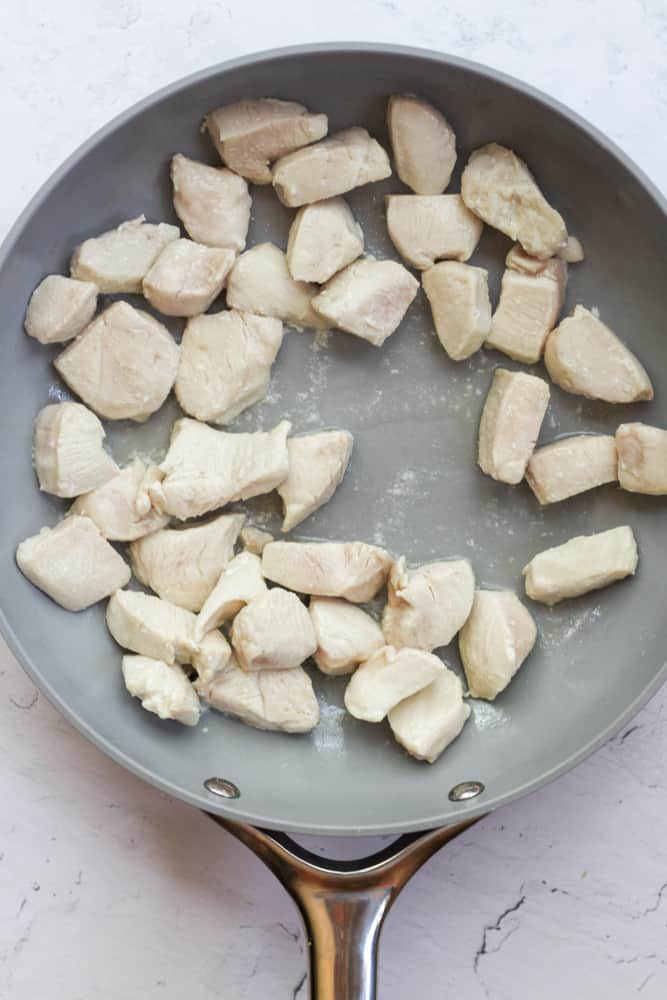 cooked chicken breast in a gray pan.