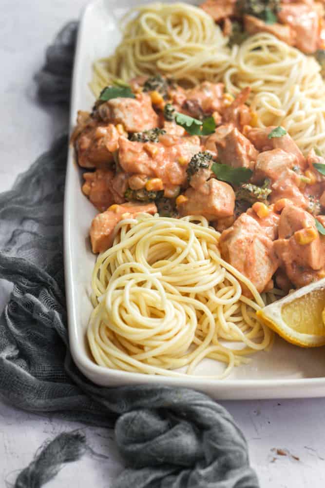 spicy chicken chipotle pasta with spaghetti on a white plate.