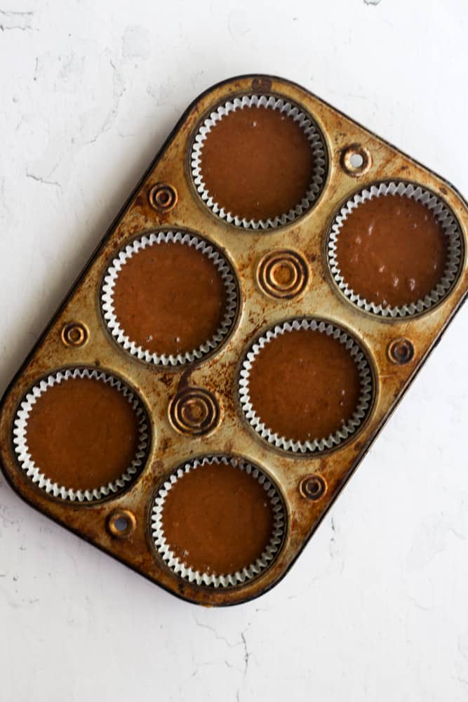 healthy chocolate cupcake batter without eggs in a muffin tin.