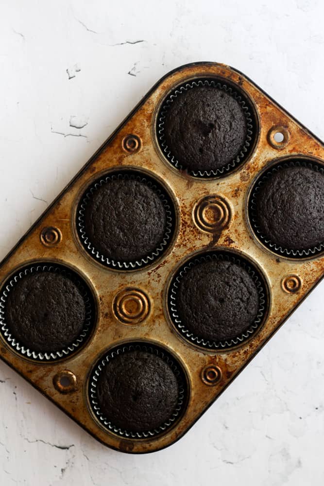 healthy chocolate cupcakes with no eggs baked in a muffin tin.